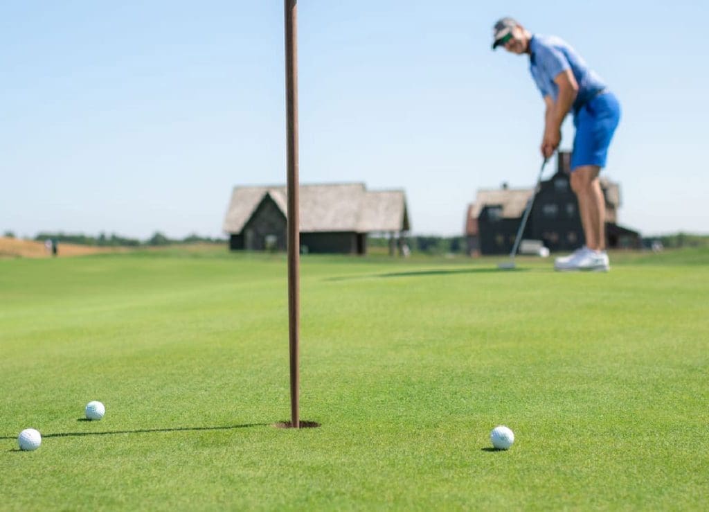 Image of a golfer putting on Drumlin green